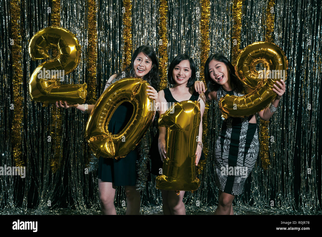 nice beautiful adorable pretty glamorous charming cheerful glad funny ladies cocktail party. girls chill out at nightclub holding 2019 golden symbol f Stock Photo