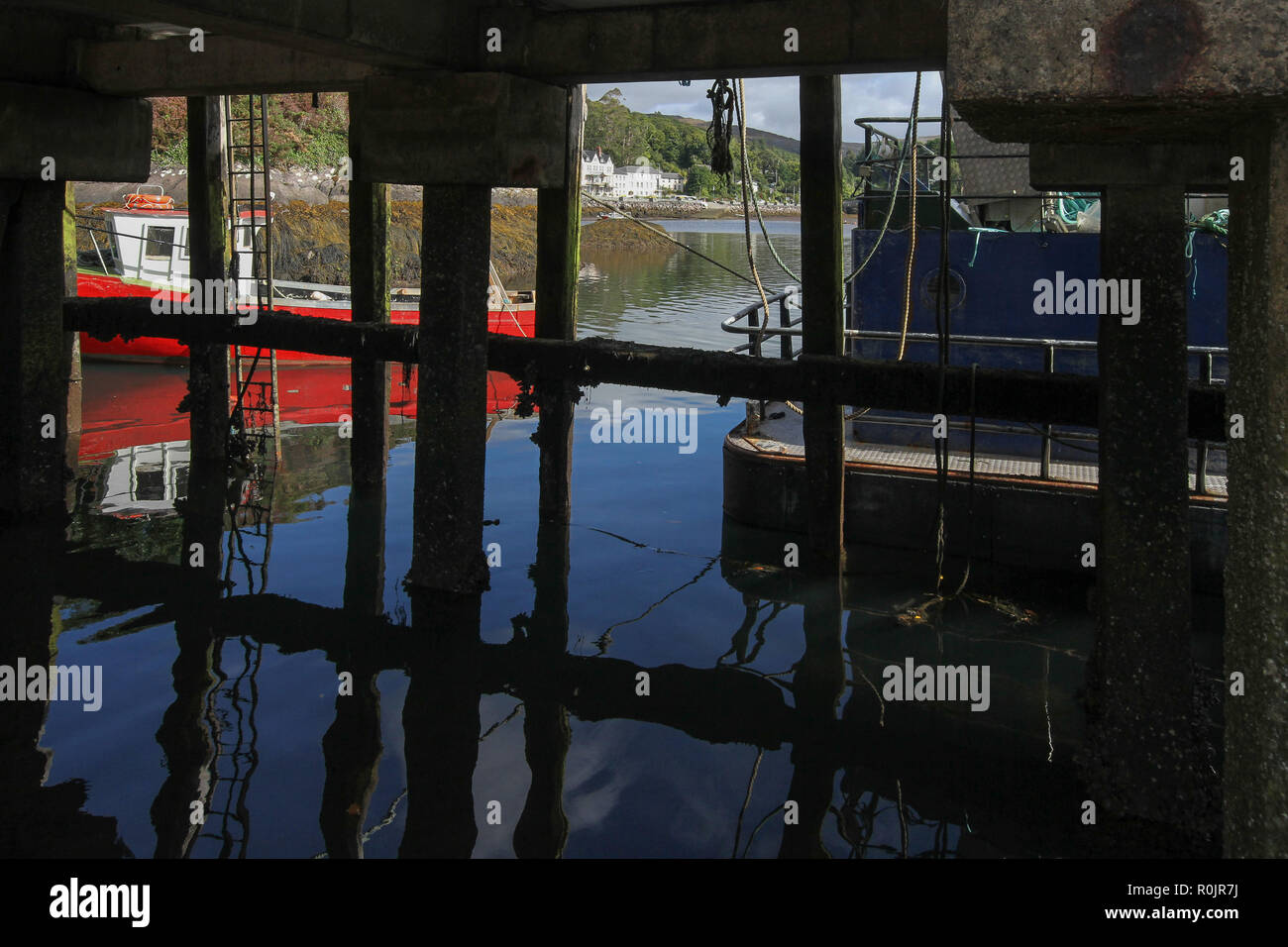 Boats moored alongside a harbour pier at Glengarriff, Bantry Bay