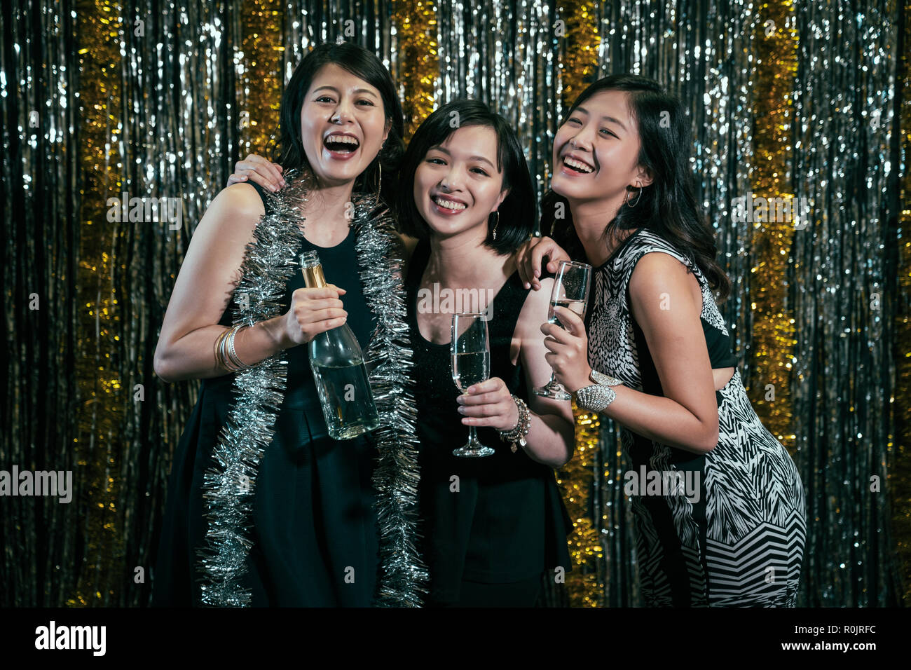 Group of friends at club having fun. young girls join New year's party in nightclub for free ladies night. girlfriends smiling holding champagne love  Stock Photo