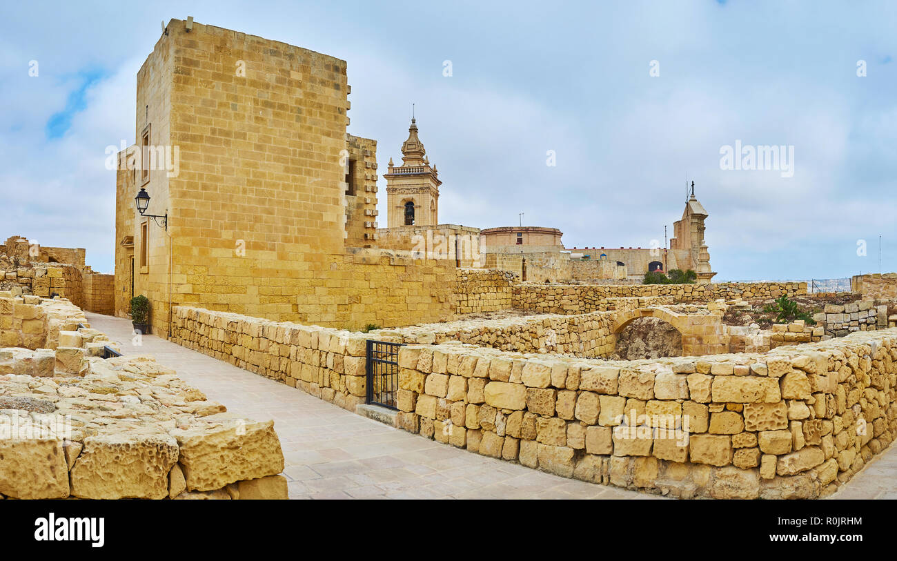 Walk the medieval street of Rabat Fortress with a view on the tall wall ...