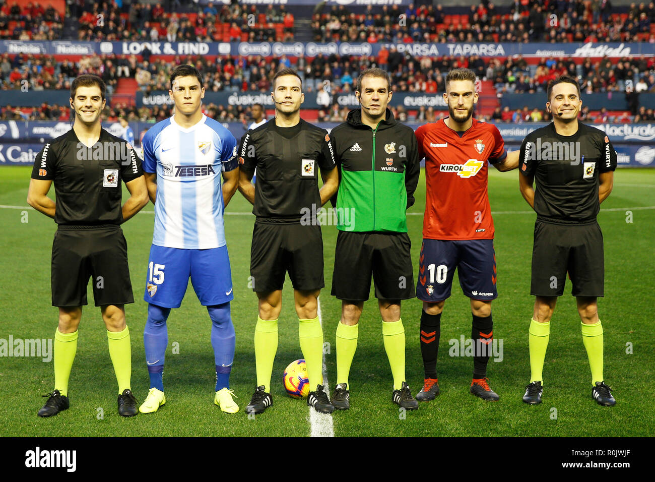 Captain of CA Osasuna Miguel Flaño and captain of Malaga CF Federico Ricca  are seen with 3 referees before the Spanish football of La Liga 123 match  between CA Osasuna and Málaga