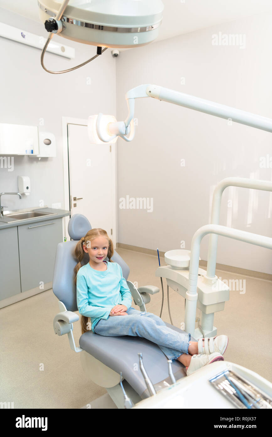 high angle view of adorable little child sitting in dental chair at dentist  office Stock Photo - Alamy