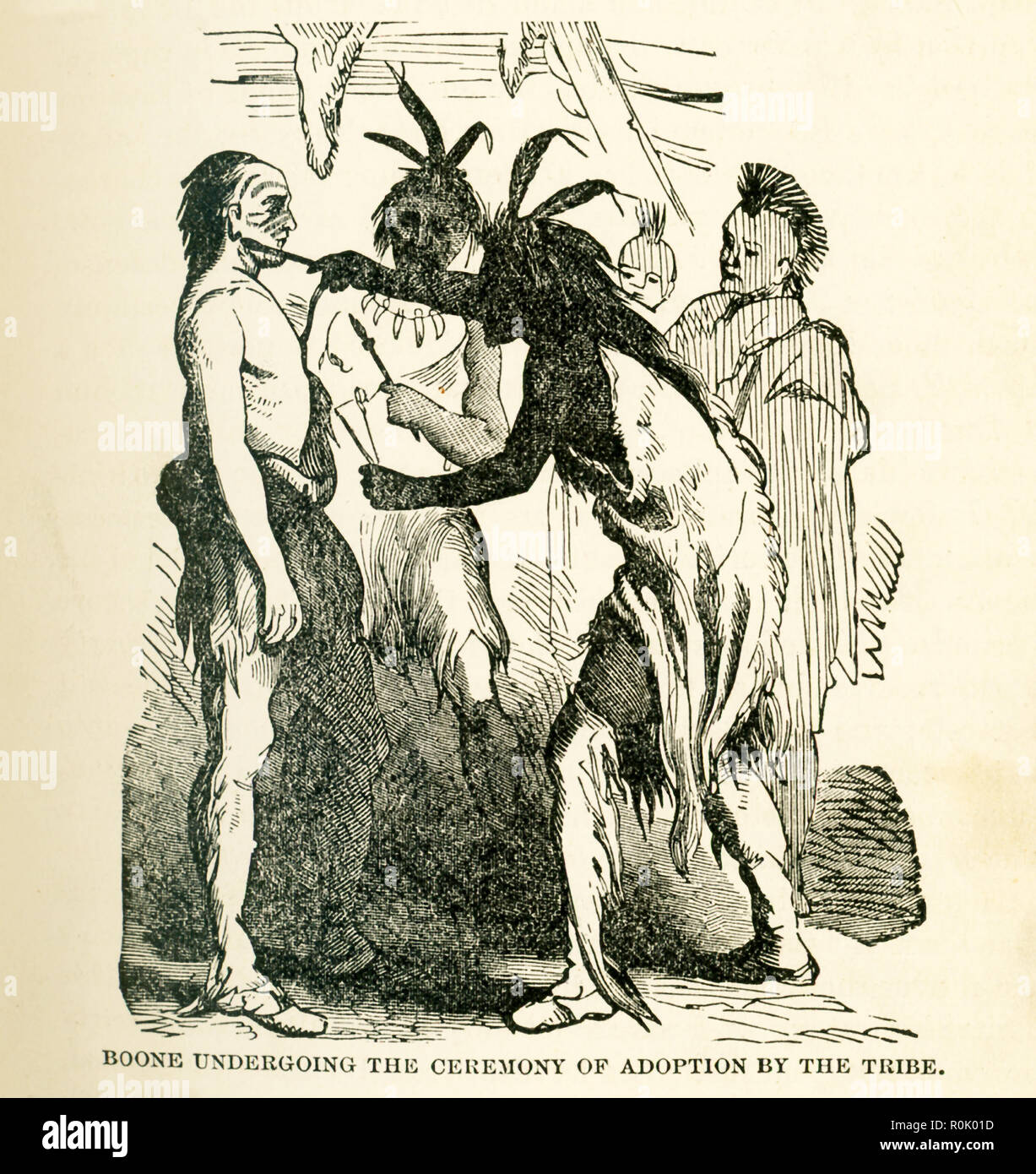 The caption reads: Boone Undergoing ceremony of adoption by the tribe. Here, Blackfish, chief of the Shawnee, performs the adoption ceremony of Boone into the tribe. Blackfish adopted Boone as his son (Blackfish's favorite son had died in battle). Boone agreed and remained for a while - when the Shawnee were preparing another attack, Boone escaped and returned to Boonesborough. This illustration is from the book titled: Story of the Wild West and Camp Fire Chats: Being the Complete and Authentic History of the Great Heroes of the Western Plains, Buffalo Bill, Wild Bill, Kit Carson, Daniel Boon Stock Photo