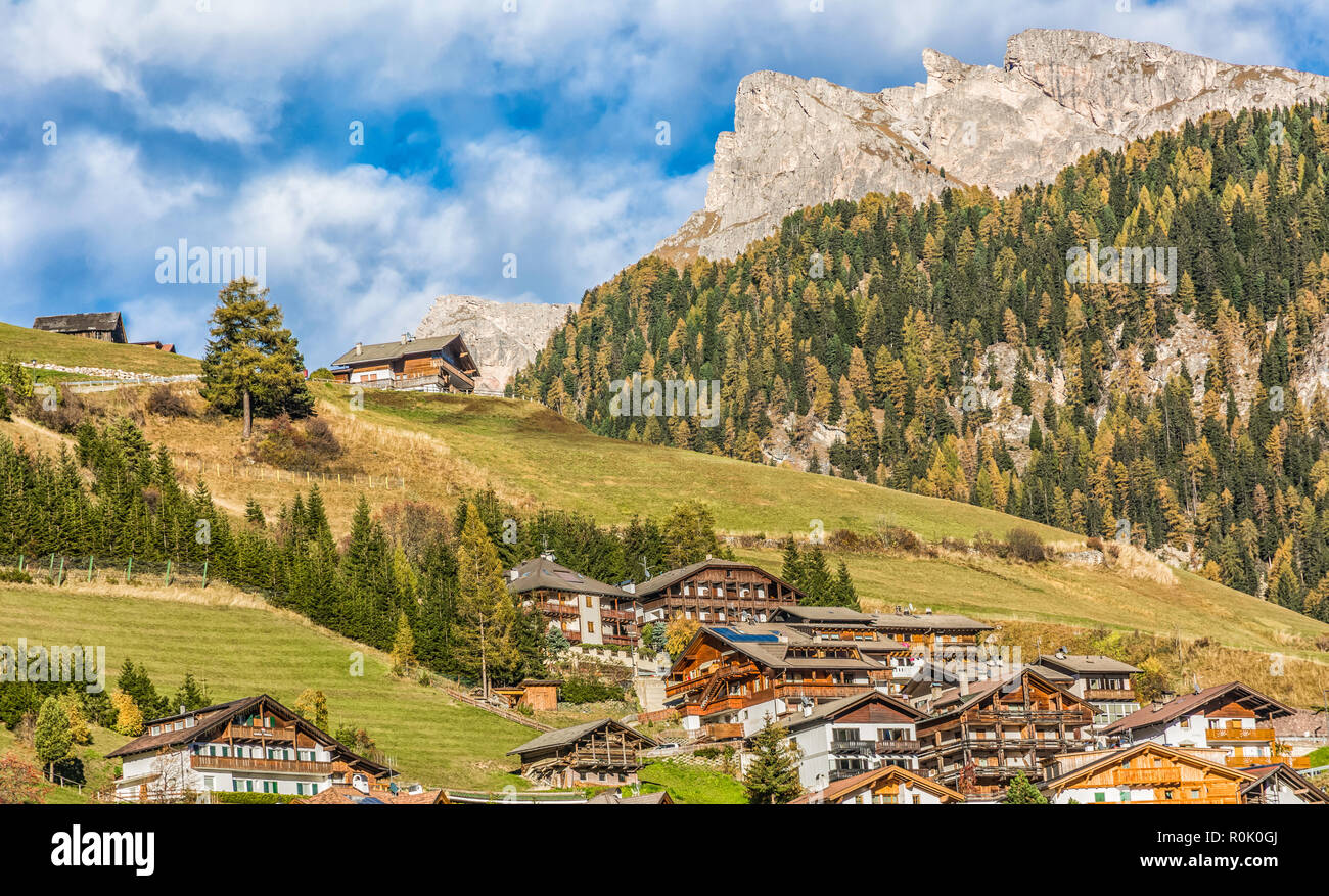 autumn landscape in Gardena Valley. The town of Santa Cristina (St. Christina in Groden) with the light of the sunset, located in the heart of Dolomit Stock Photo