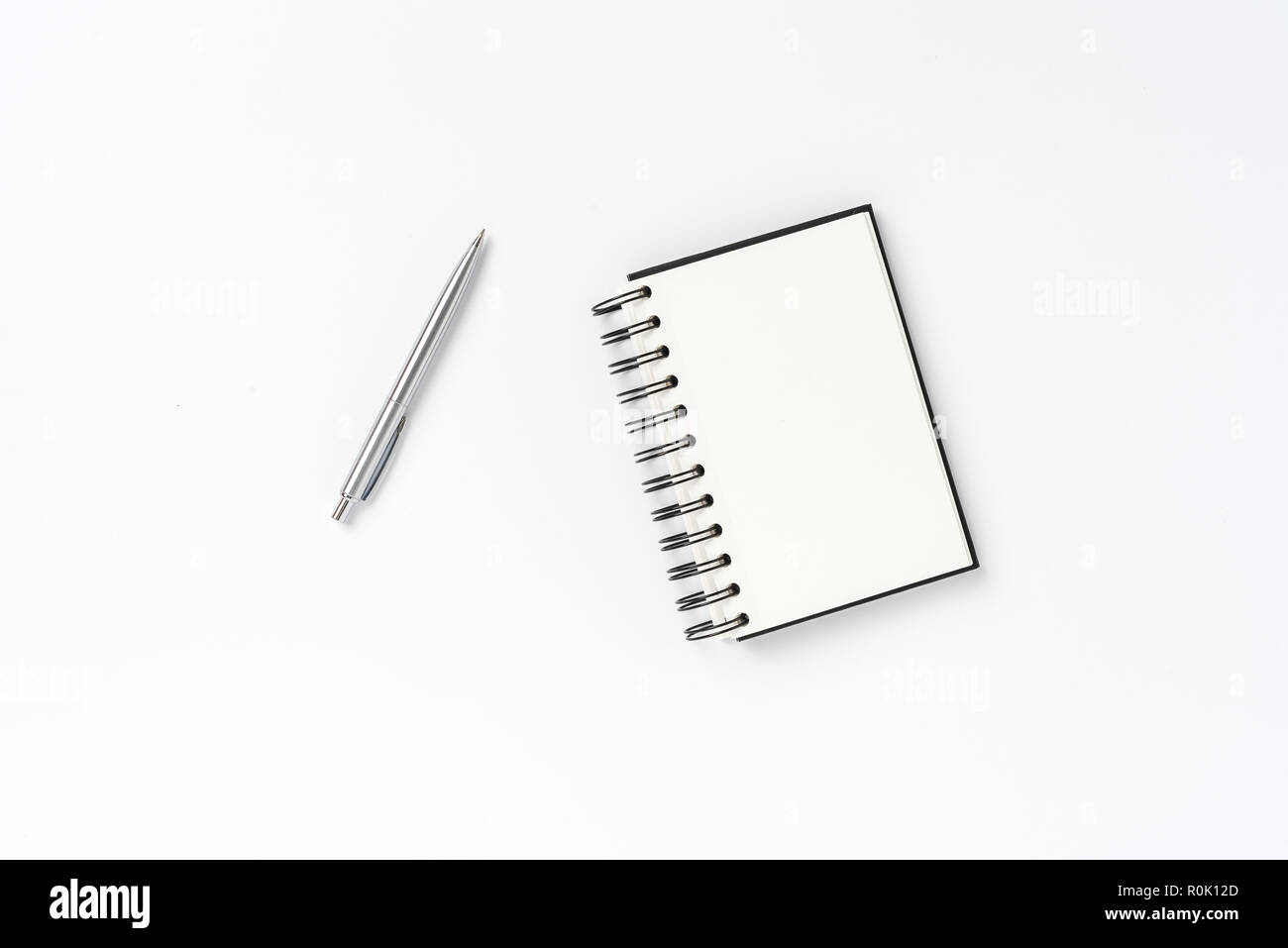 Notepad with pen on white background Stock Photo - Alamy