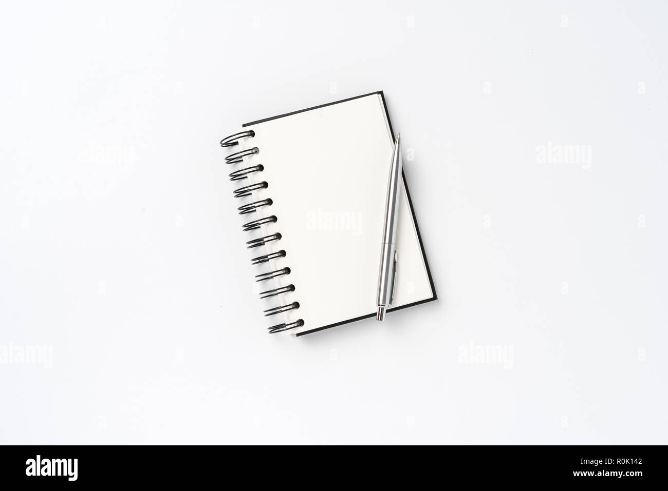 Notepad with pen on white background Stock Photo - Alamy