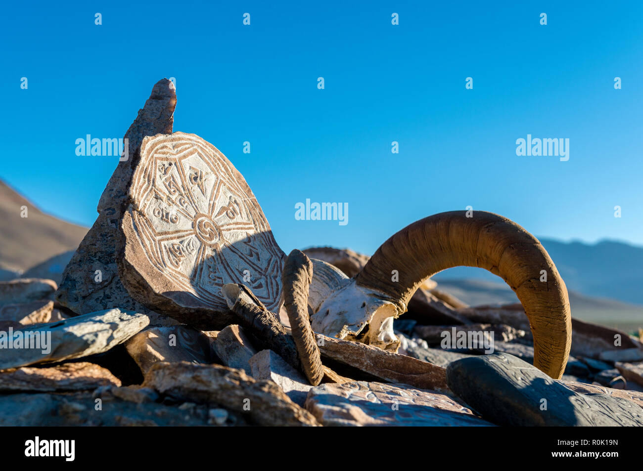 Mani walls, often placed along the roadsides or village entrances, are constructed by devotionally carved stones or animal skulls, mainly display the  Stock Photo