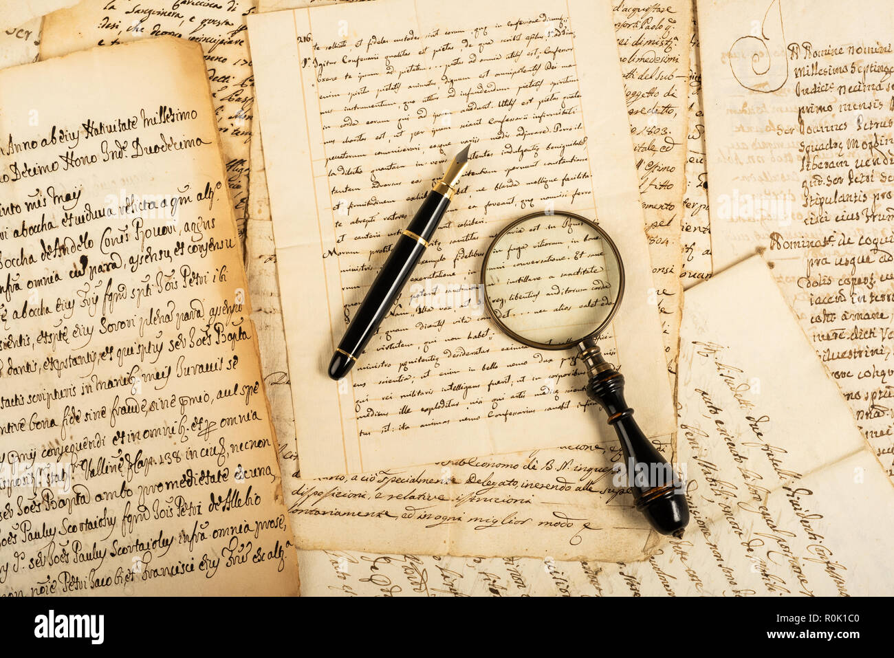 Fountain pen and magnifying glass with letters Stock Photo - Alamy