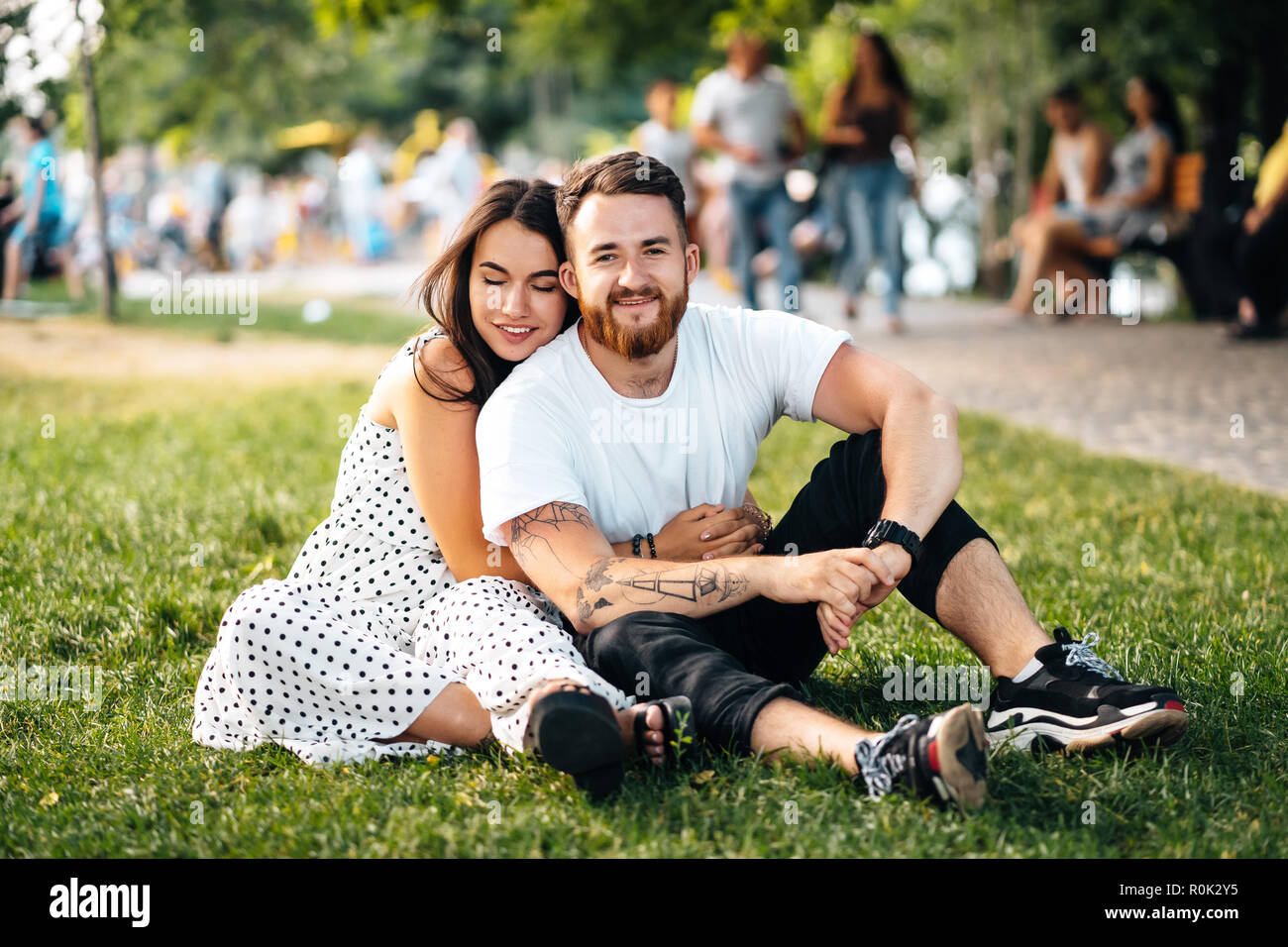 Beautiful young girl hugging her handsome guy in the park Stock Photo ...