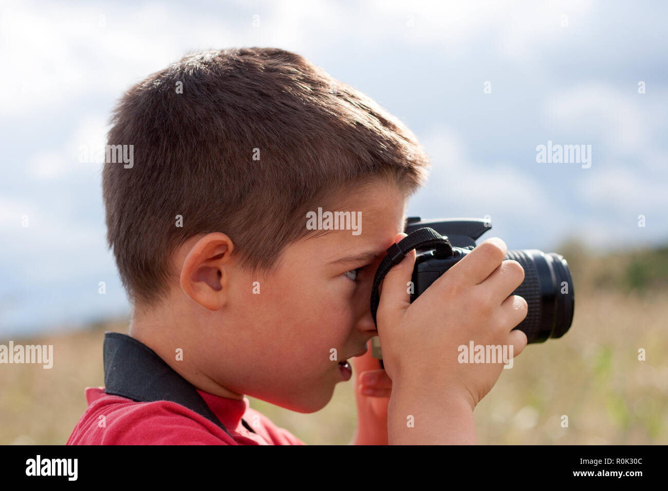 A portrait of a young boy, taking photos Stock Photo