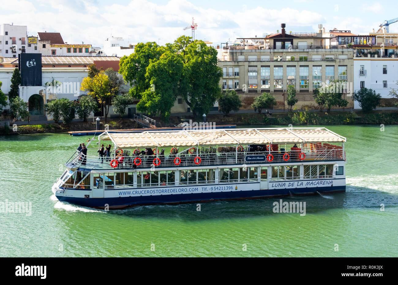 Site-seeing boat on the Rio Guadalquivir in Seville, Spain Stock Photo