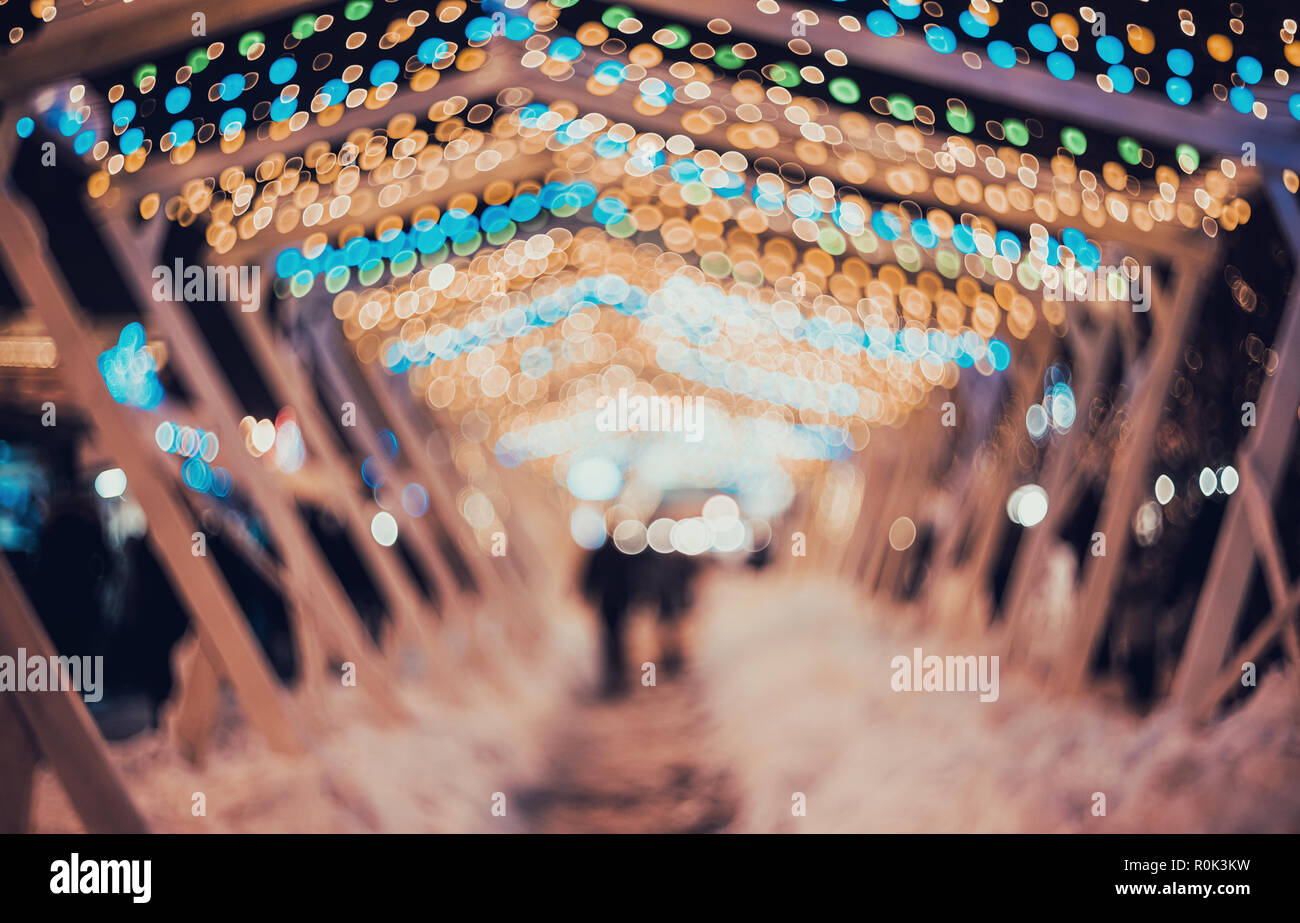 Blurred city with christmas lights at night. New Year bokeh background. Beautiful abstract background with defocused city lights, people. Defocused ur Stock Photo