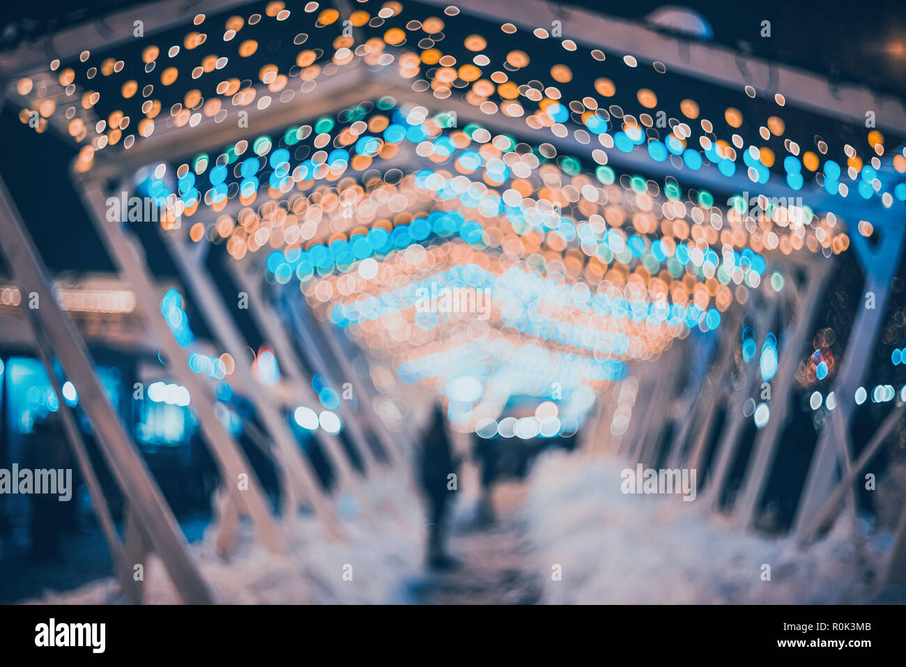 Blurred city with christmas lights at night. New Year bokeh background. Beautiful abstract background with defocused city lights, people. Defocused ur Stock Photo