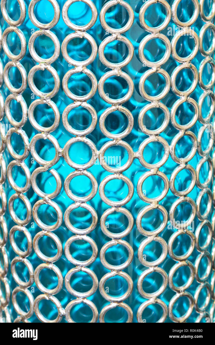 Silver metal mesh at blue glass pattern Stock Photo