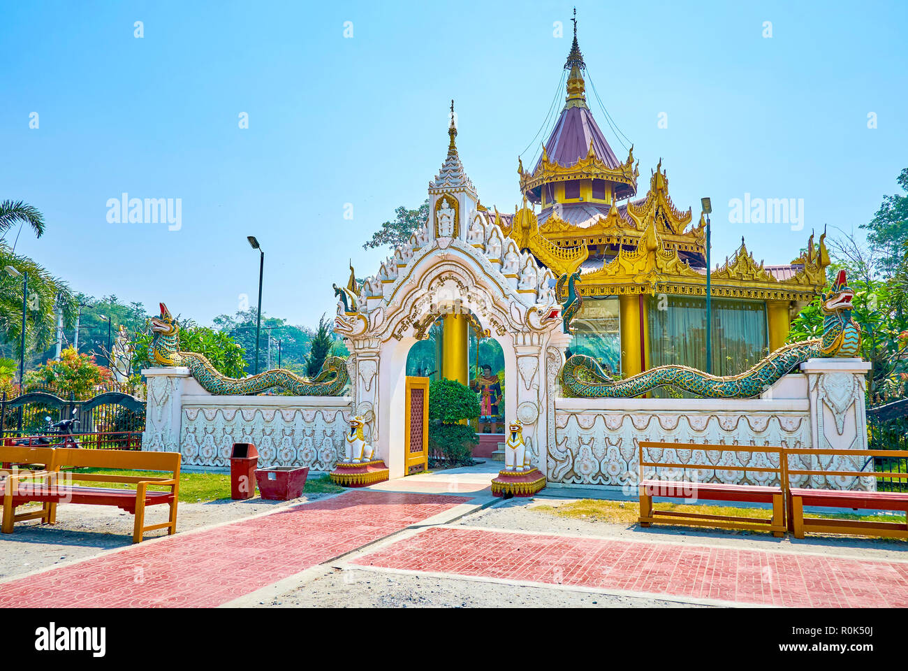 The marble gates of small pavilion decorated with sculptures of peacocks, white elephants, dragons-serpents Nagars and rows of Nats (spitits), Mandala Stock Photo