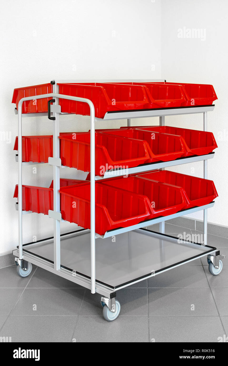 Inventory cart with plastic red boxes for warehouse Stock Photo Alamy
