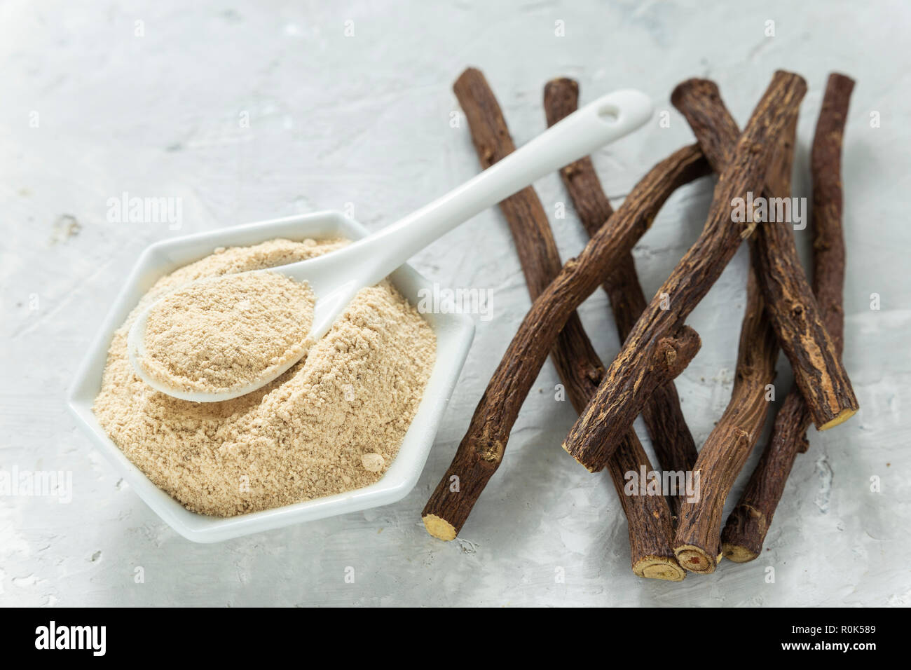 Powder and licorice root on the table Glycyrrhiza glabra Stock Photo