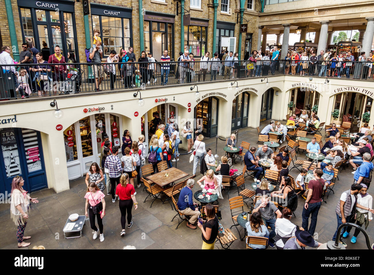 London England,UK,Covent Garden,market,shopping dining entertainment,Charles Fowler,neo-classical,central hall building,1830,stores,tables,seating,cro Stock Photo
