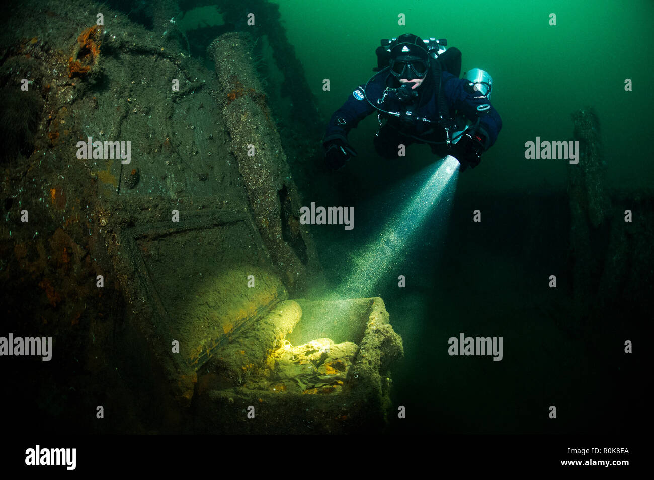 Diver discovering a box of ammunition at the wreck of the German escort ship V 1605. Stock Photo