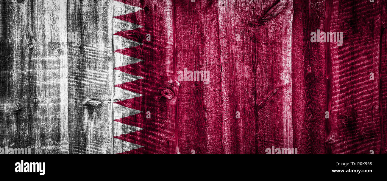 National flag of Qatar on a textured wooden background, fence or wall ...