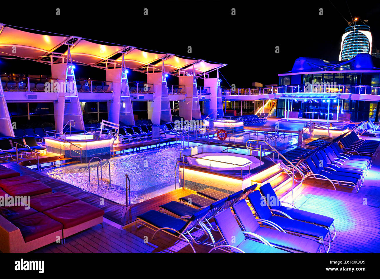 Nassau, Bahamas-2 October, 2017: Cruise ship swimming pool at night on the top deck with scenic views Stock Photo