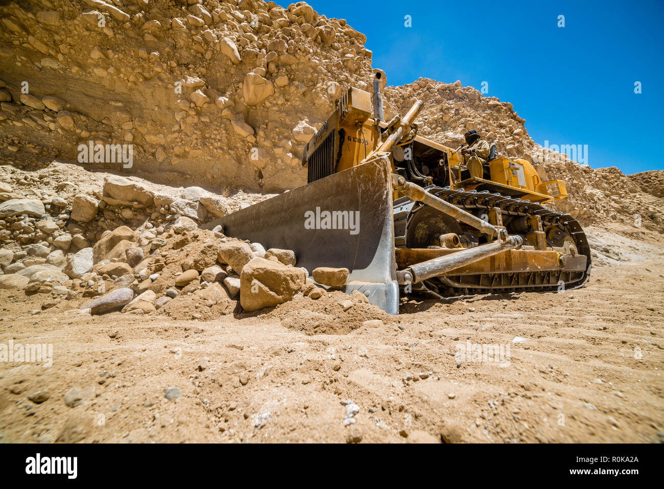 Yellow Power Shovel In The Dirt Spotted In A Quarry Stock Photo