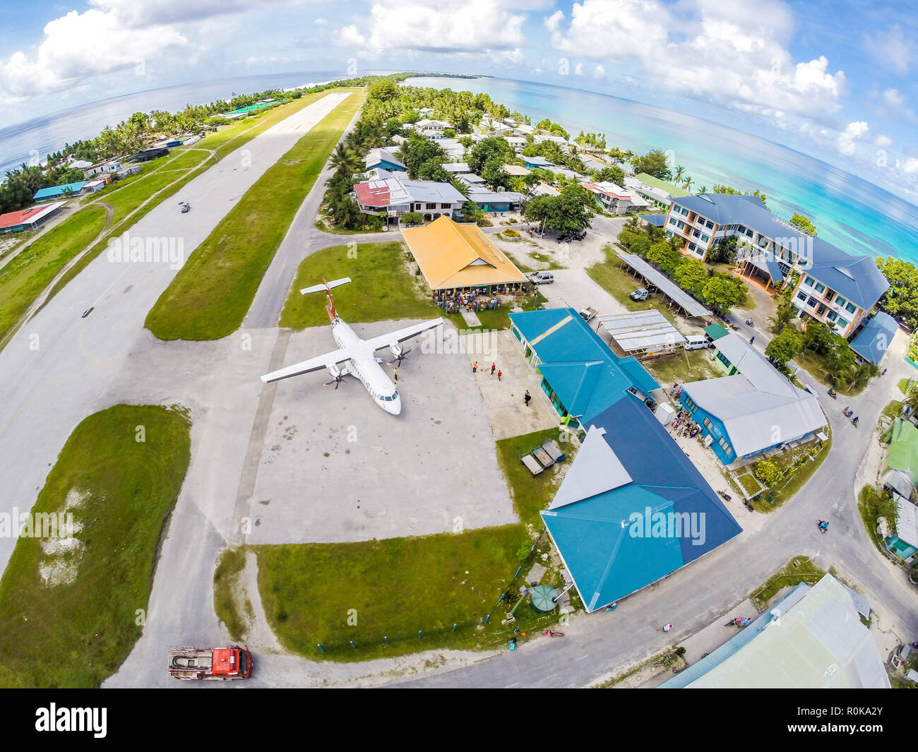 An airplane on the apron of Tuvalu international airport, just arrived. Vaiaku village, Fongafale motu, Funafuti atoll, Polynesia, South Pacific Ocean. Stock Photo