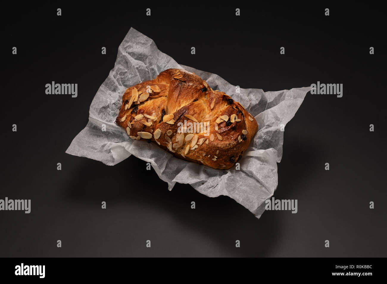 Freshly baked Easter bread with chocolate and almonds isolated on black background Stock Photo