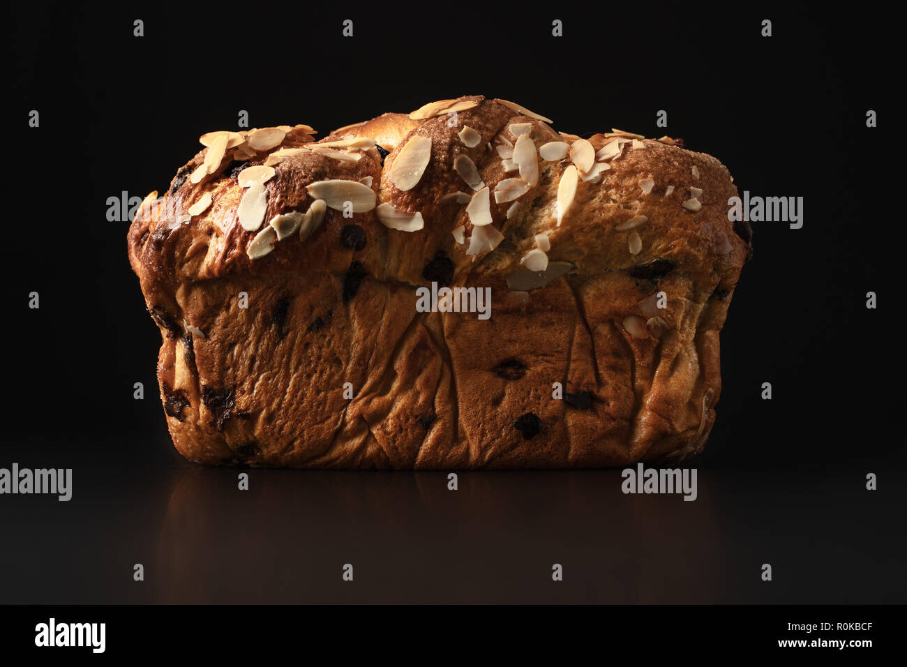 Easter bread with chocolate and almonds isolated on black background. Stock Photo