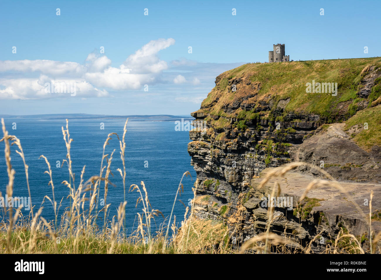 A view of O'Brien's Tower on top of the Cliffs of Moher overlooking the Atlantic ocean and Aran Islands on west coast of Ireland Stock Photo