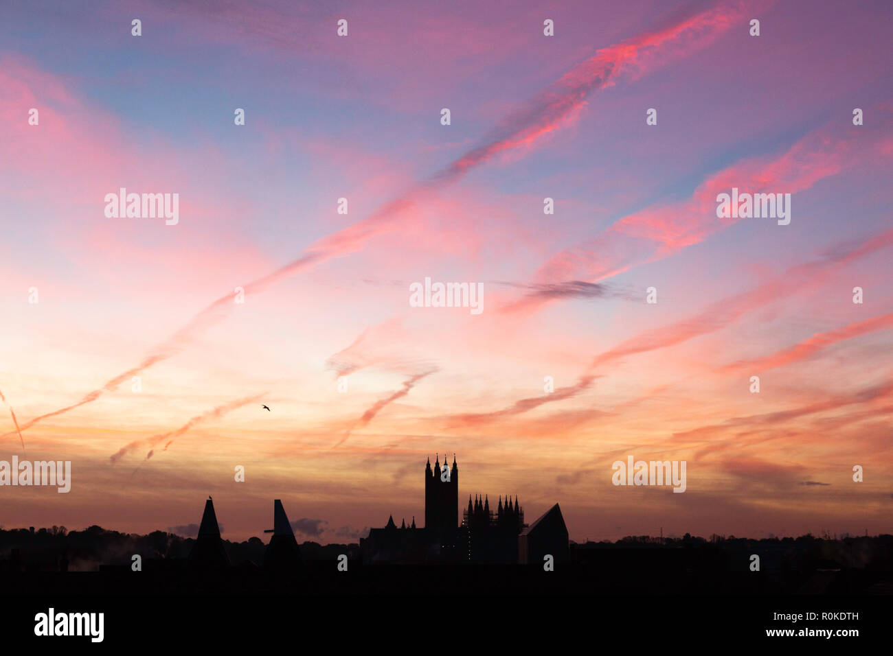 Sublime streaks of pink cloud just before dawn over Canterbury Cathedral, Kent, UK. Stock Photo