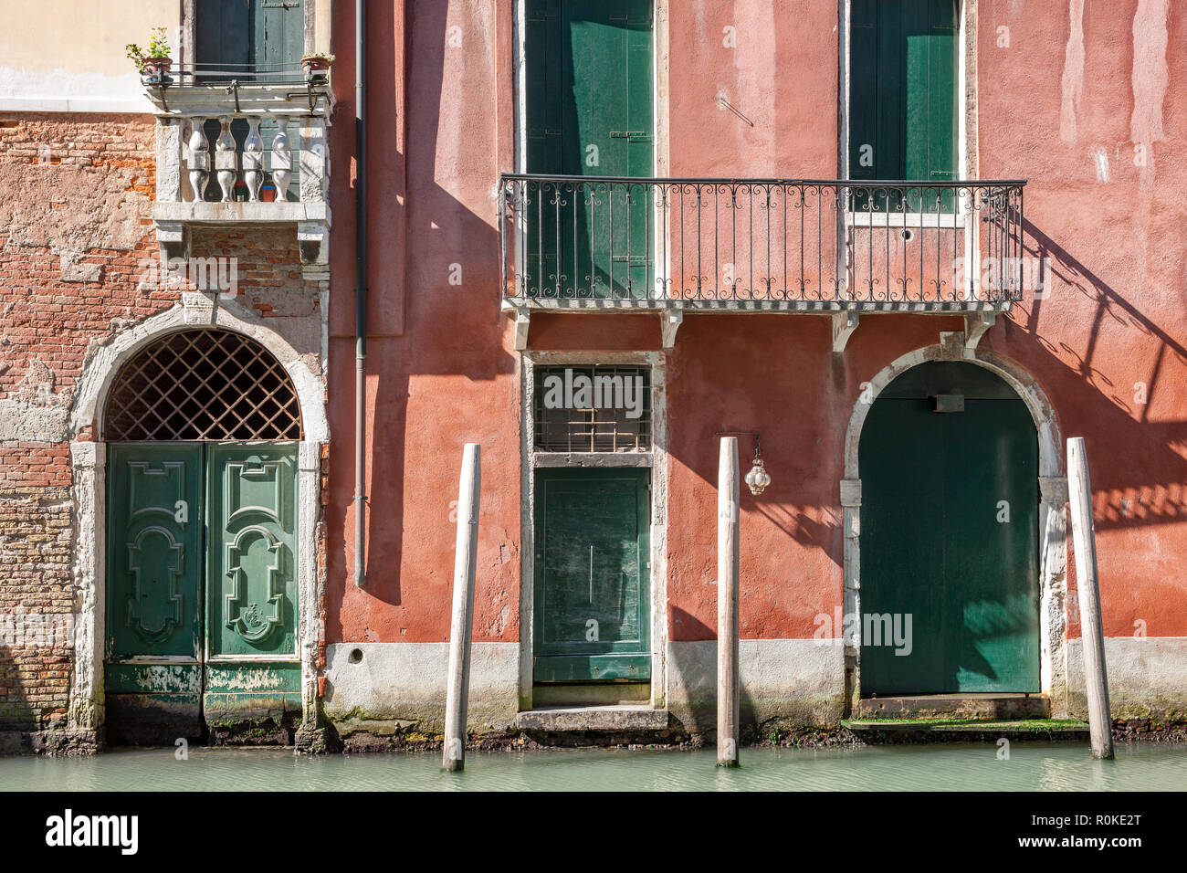 Old brick and painted buildings with balconies and doorways Venice Italy Stock Photo