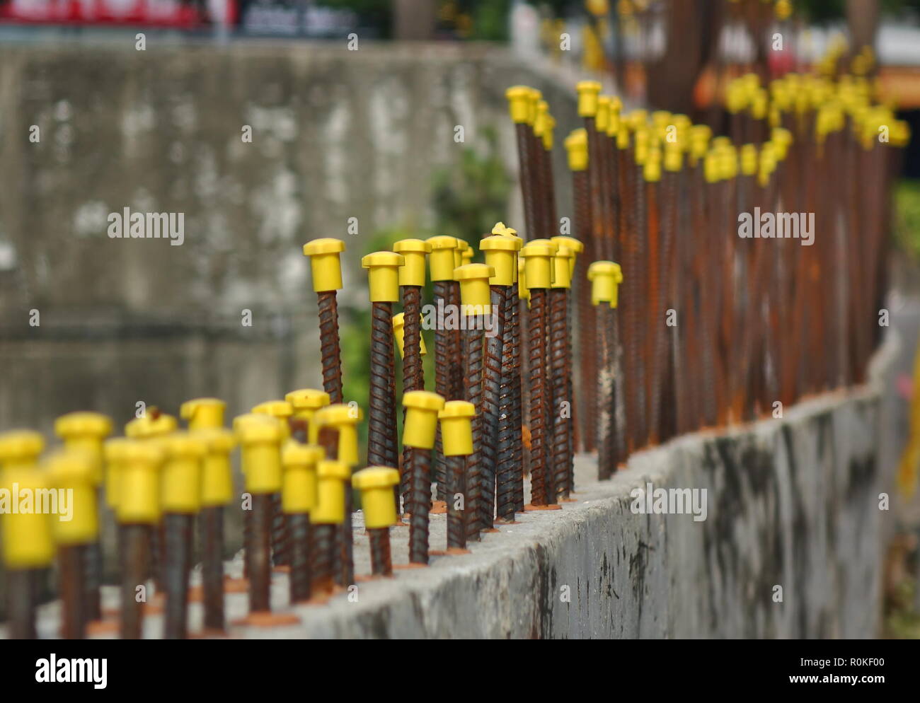 Rebar steel rods with yellow end protection caps Stock Photo