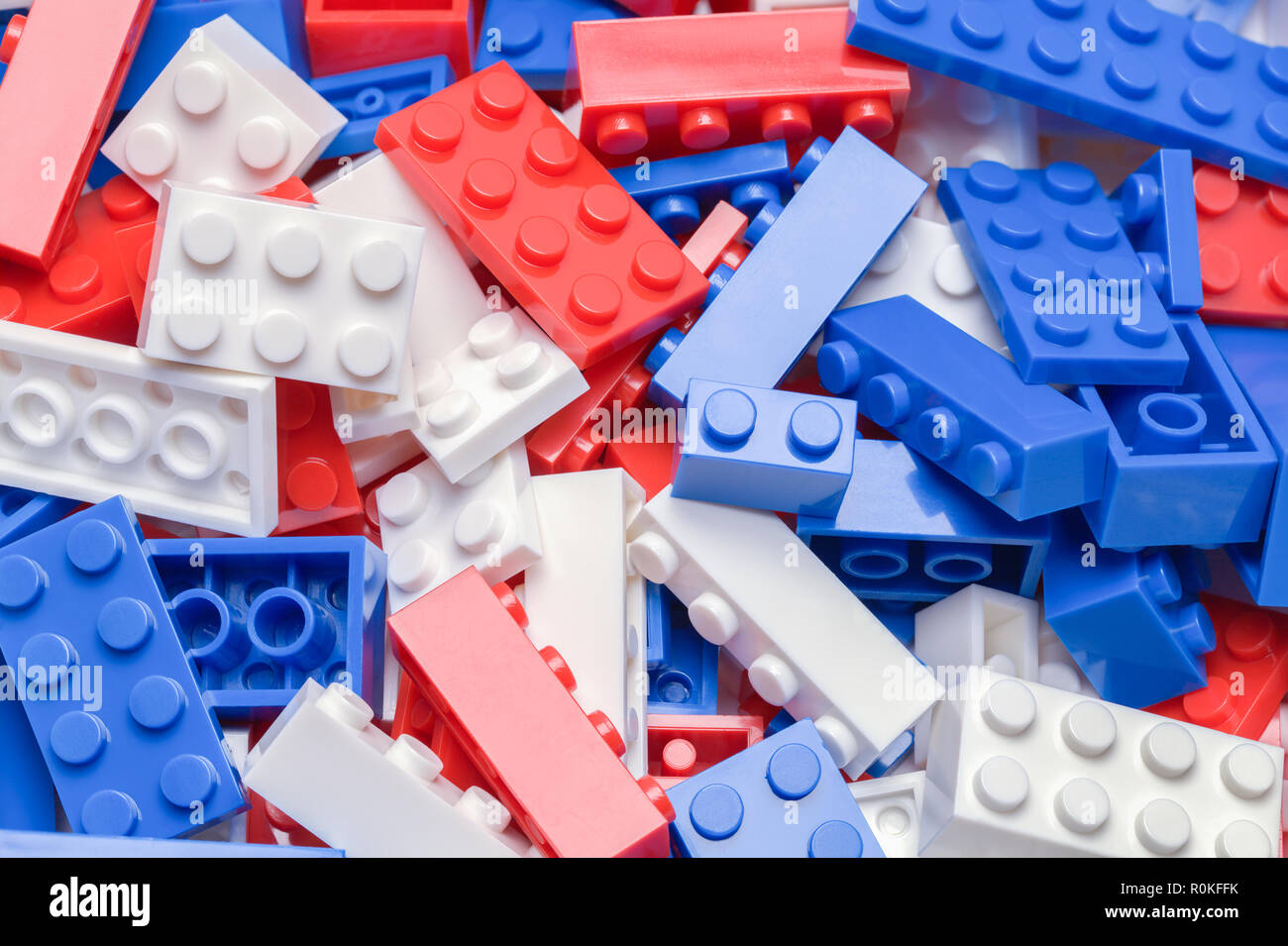 Pile of Red, White and Blue Toy Plastic Building Blocks. Stock Photo