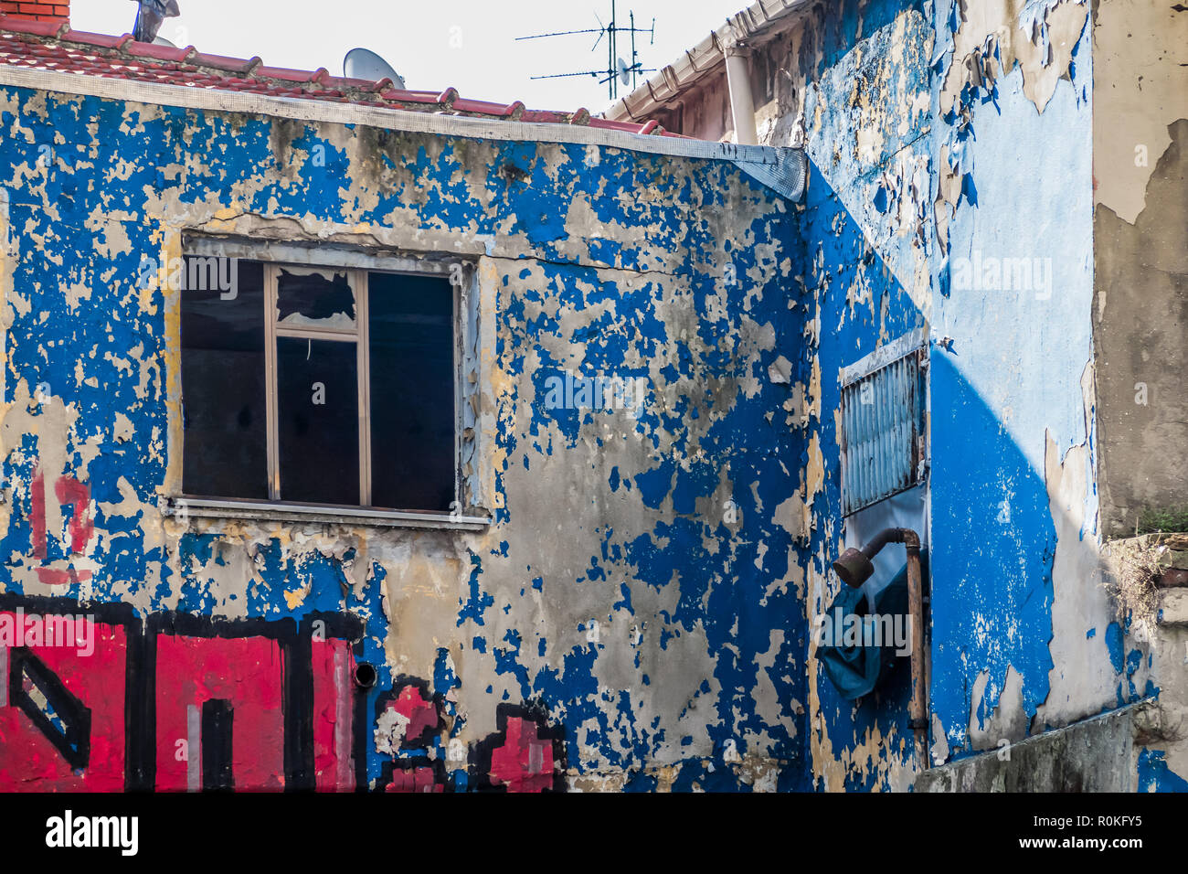 Shabby facade with flaking paint in the city centre Stock Photo