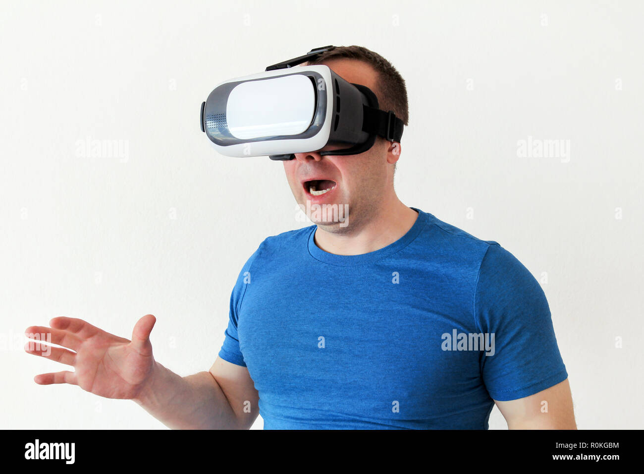 Man wearing and playing mobile game app on device virtual reality glasses  on white background. Man action and using in virtual headset, VR box Stock  Photo - Alamy