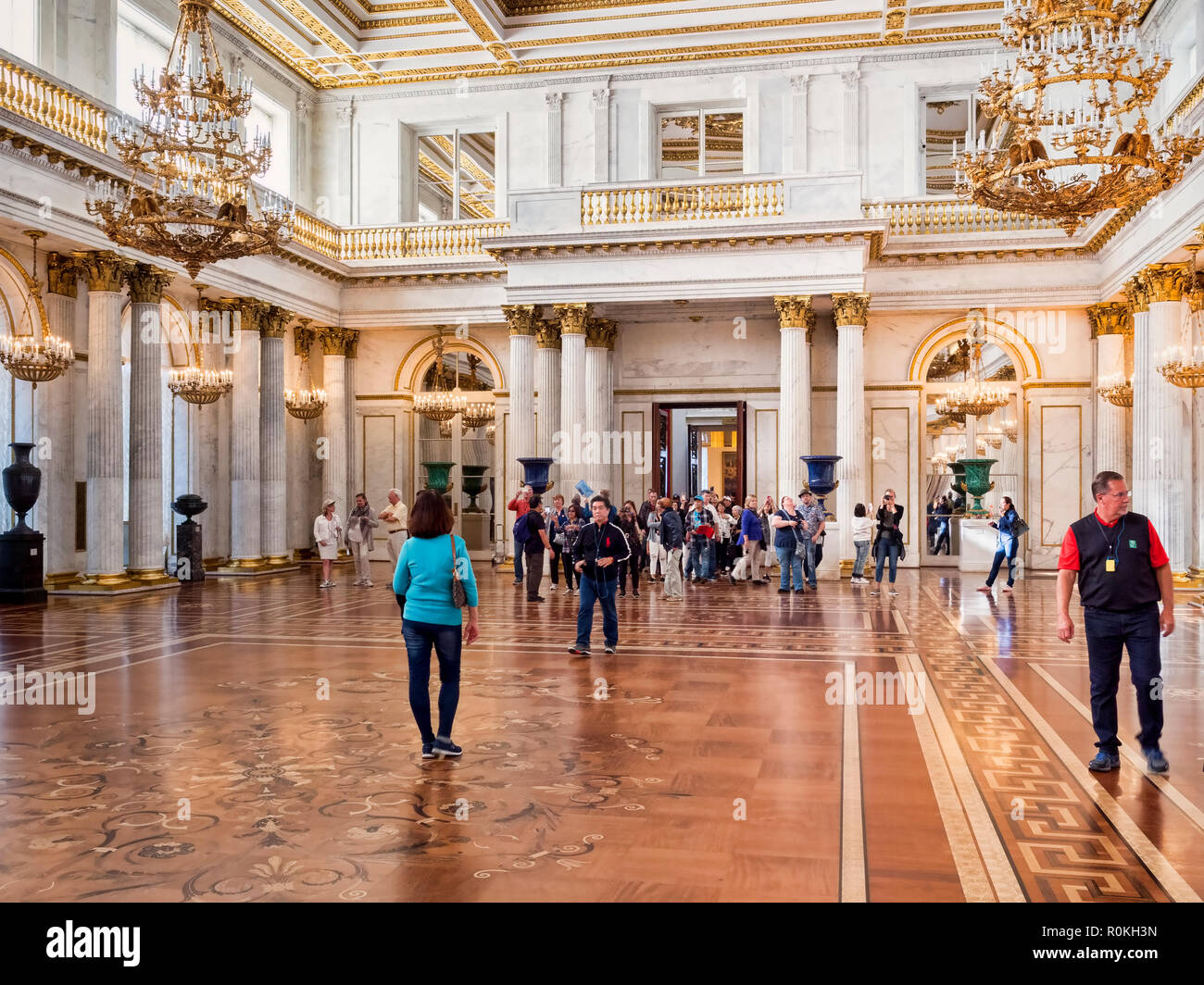 19 September 2018: St Petersburg, Russia - Visitors in St George's Hall, or the Great Throne Room, in the Winter Palace, part of the Hermitage Museum. Stock Photo