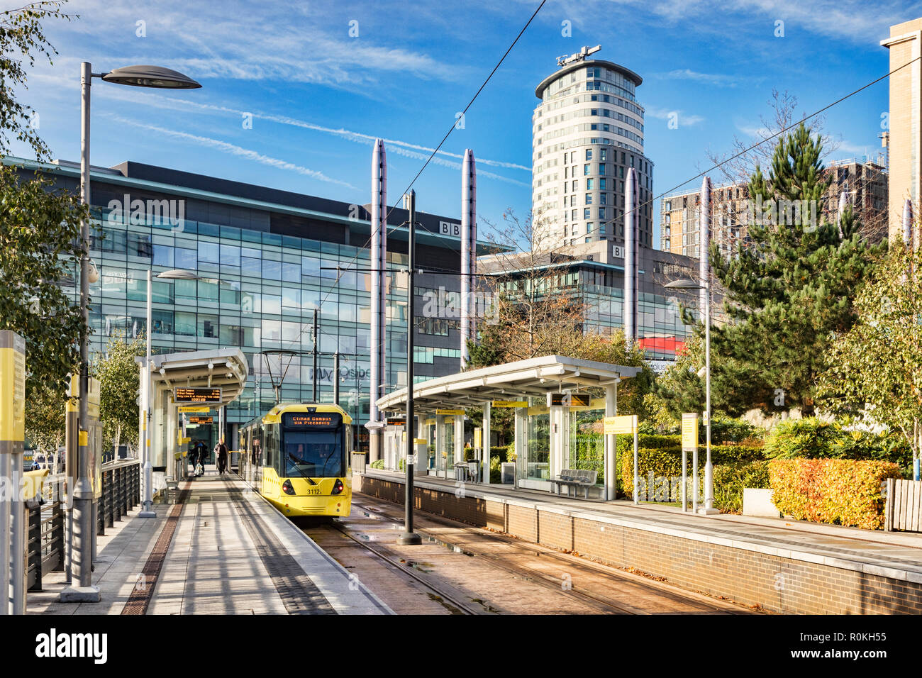 2 November 2018: Manchester, UK - Metrolink tram at Media City UK Station on a sunny autumn day with blue sky. Stock Photo