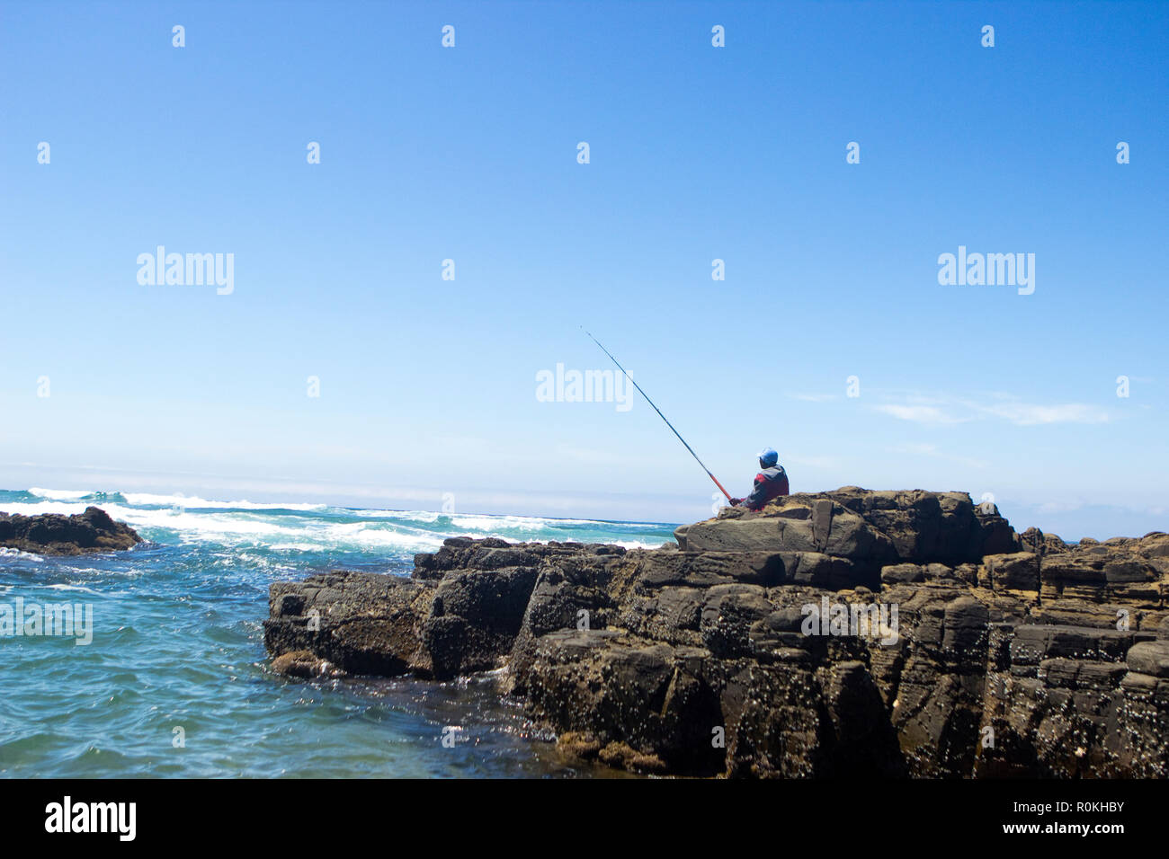 Man fishing from the rock on the Wild Coast Stock Photo