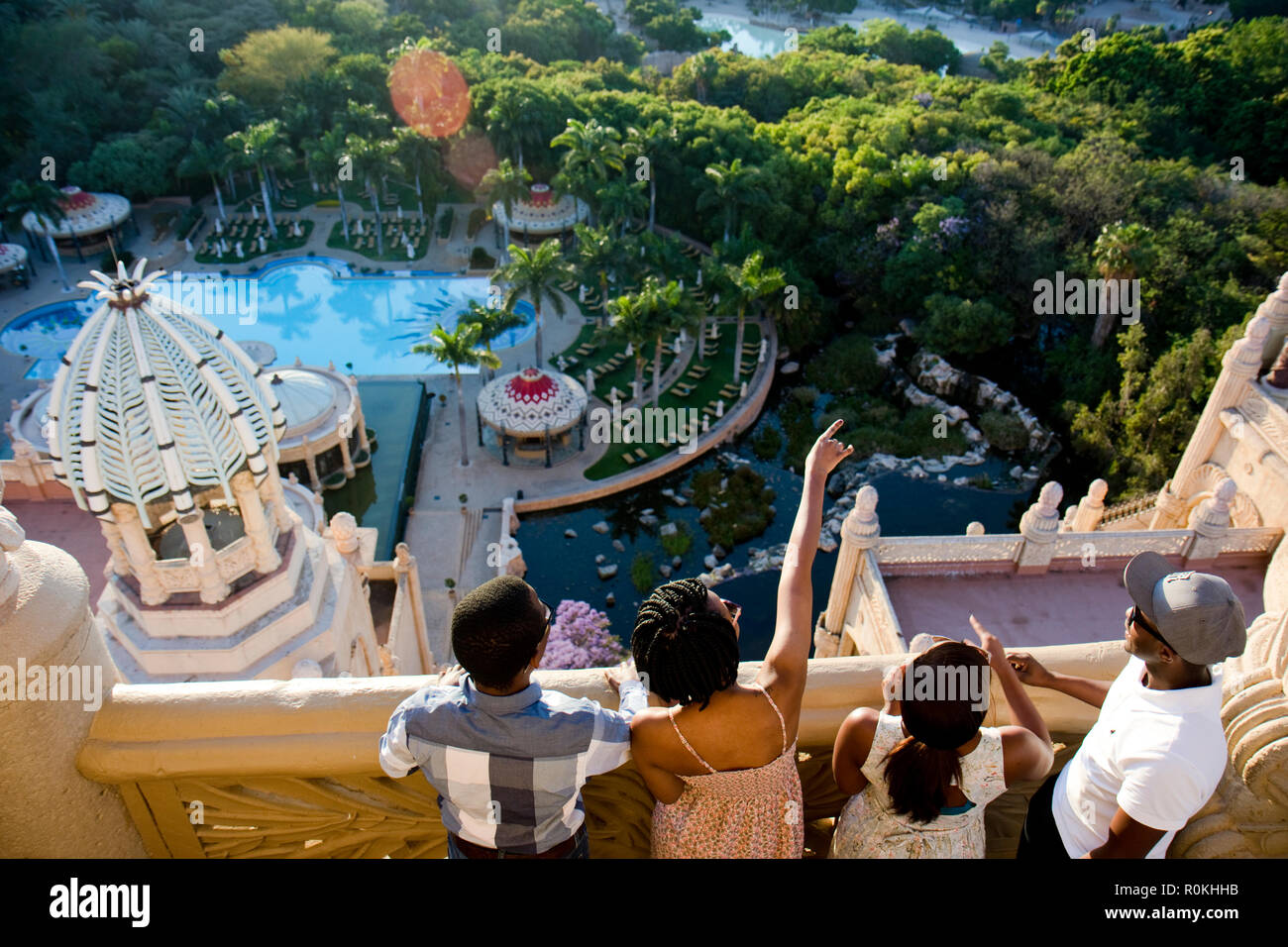Group looking out over Sun City from a balcony in the Palace Hotel Stock Photo