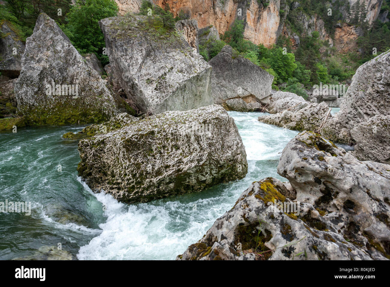 Fast flowing water of the Tarn river round huge boulders in the Gorges du Tarn Averyron France Stock Photo