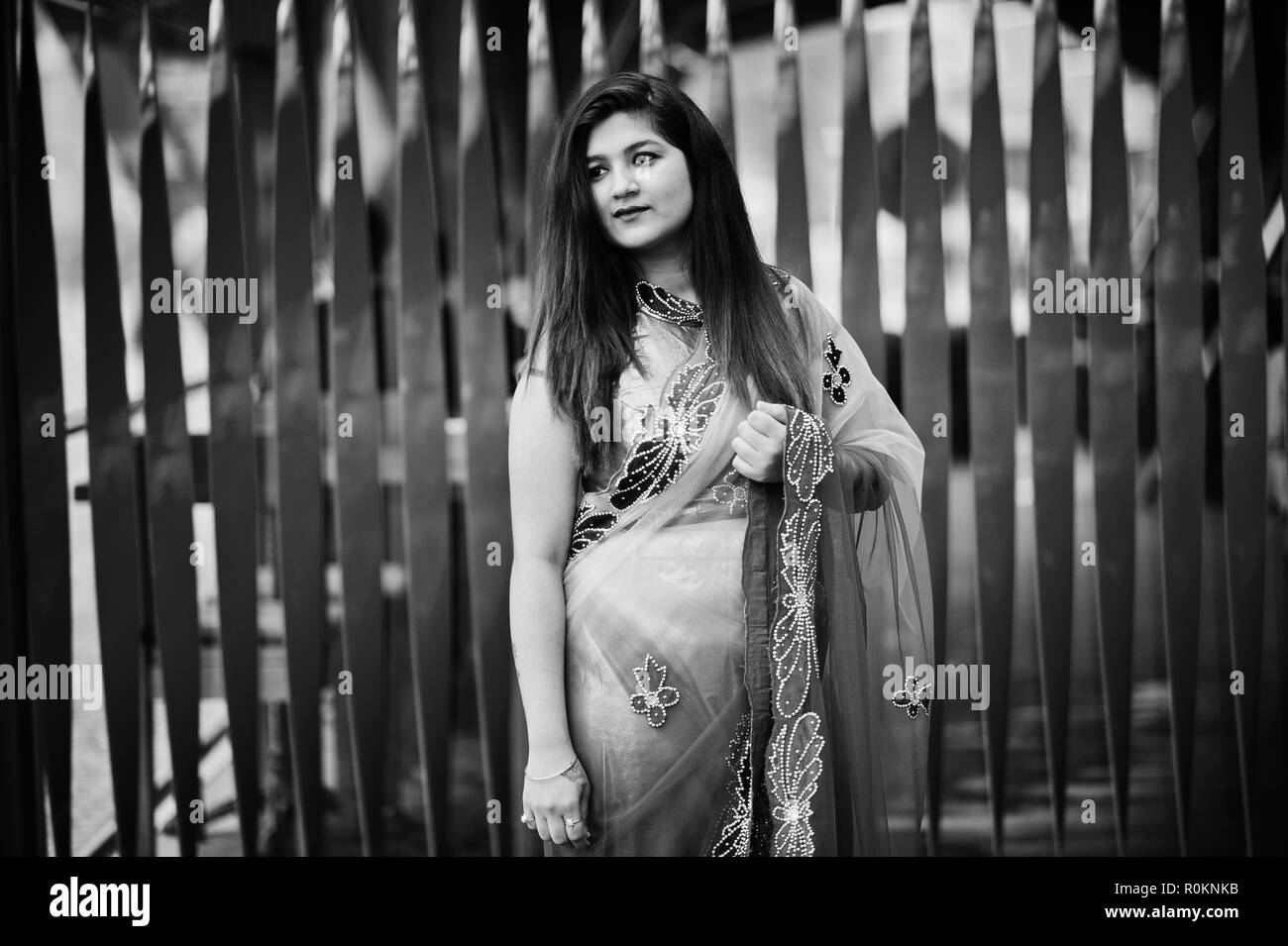 Indian hindu girl at traditional violet saree posed at street against red  background Stock Photo - Alamy