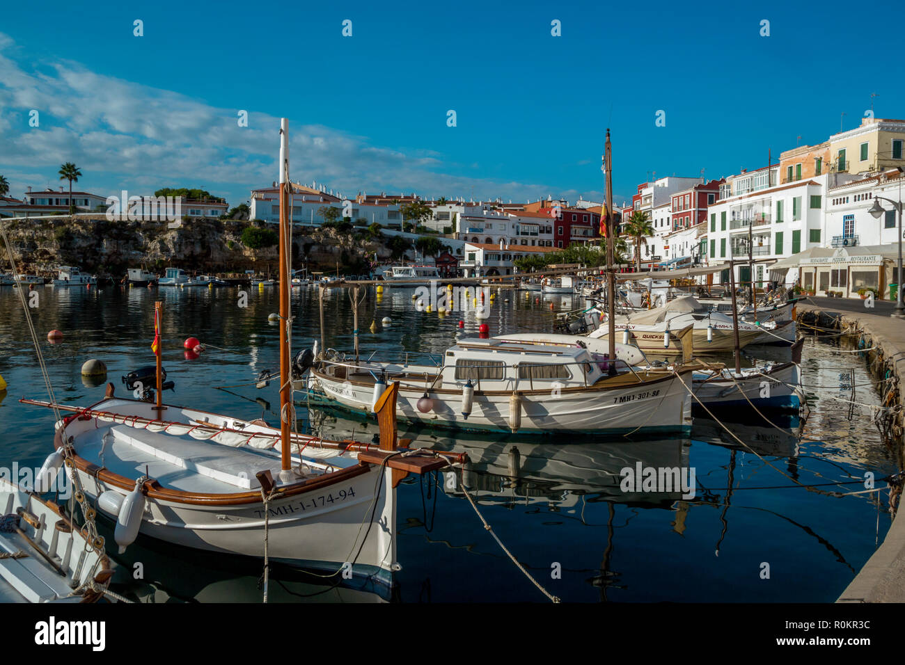 Traditional fishing boats mooring in the harbour of Es castel Stock Photo