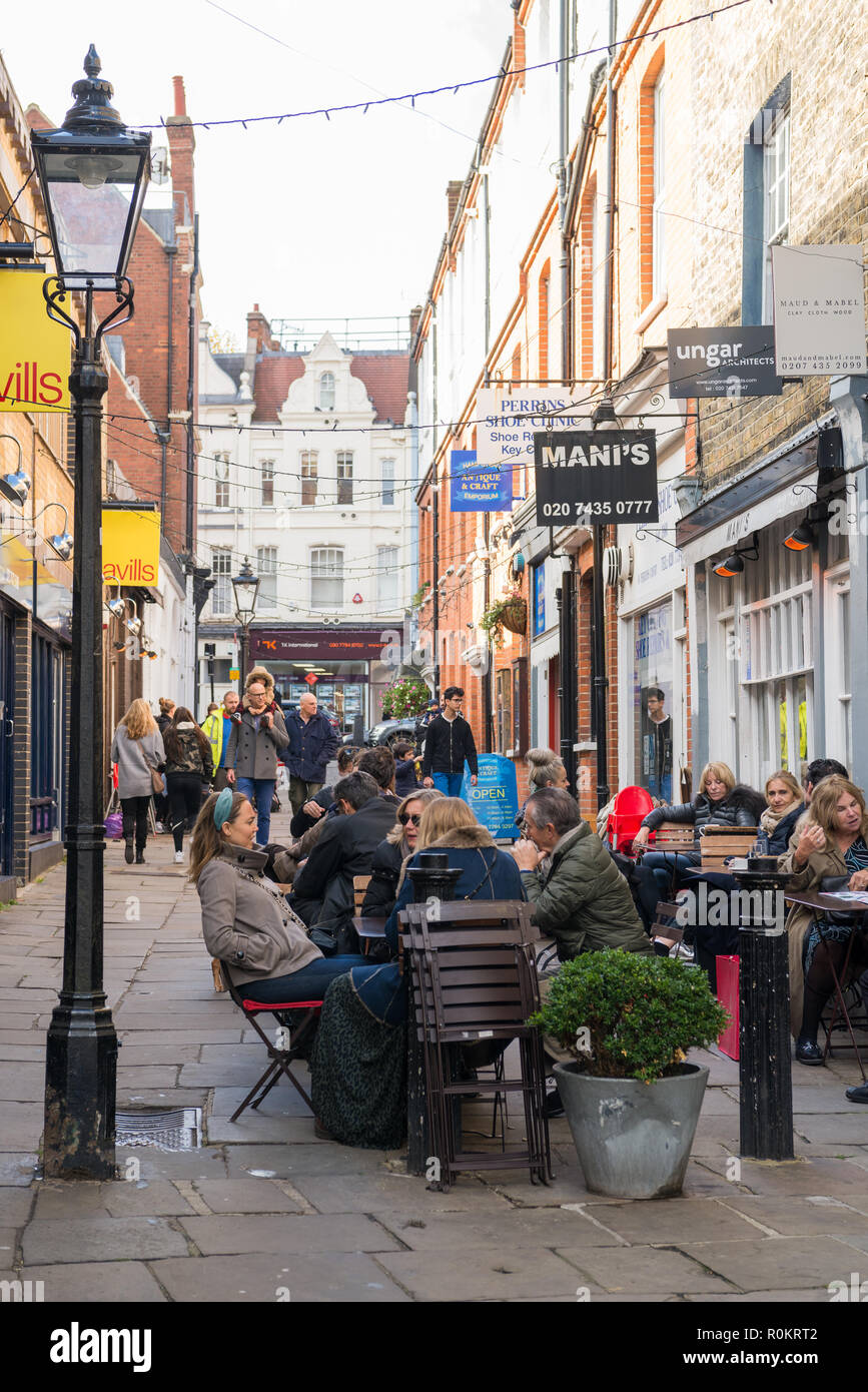 People socialising and enjoying refreshments in restaurant outdoor dining area, Perrin's Court, Hampstead, London, England, UK. Stock Photo
