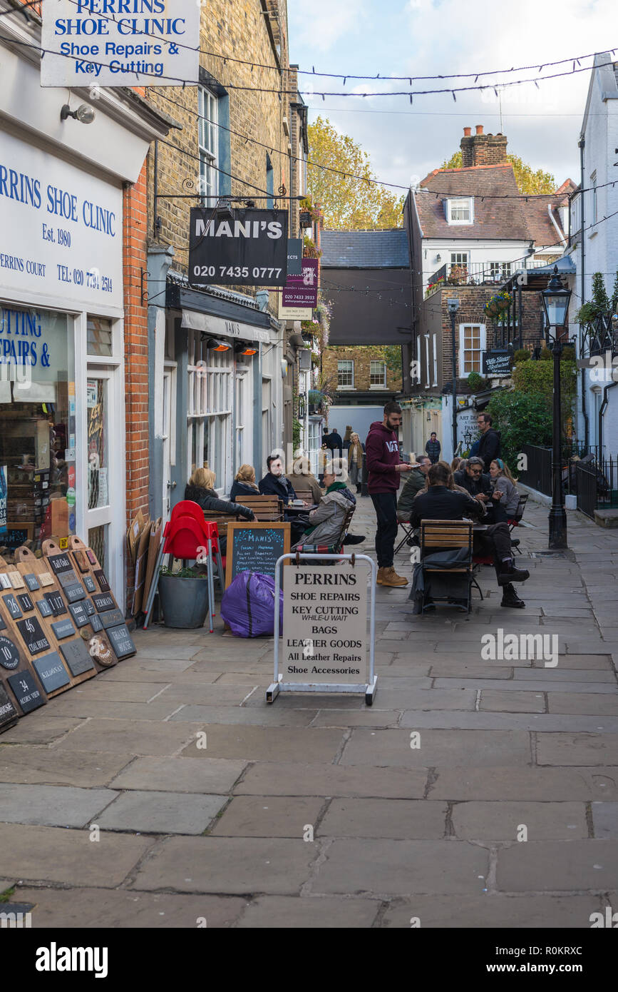 People socialising and enjoying refreshments in restaurant outdoor dining area, Perrin's Court, Hampstead, London, England, UK. Stock Photo