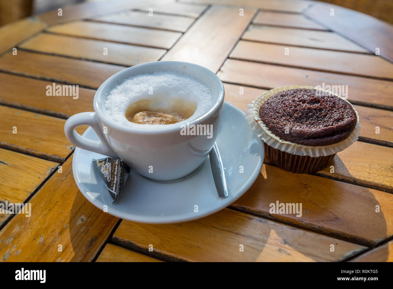 A cup of coffee with chocolate canabis muffin on the taible in the coffee shop in Amsterdam Stock Photo