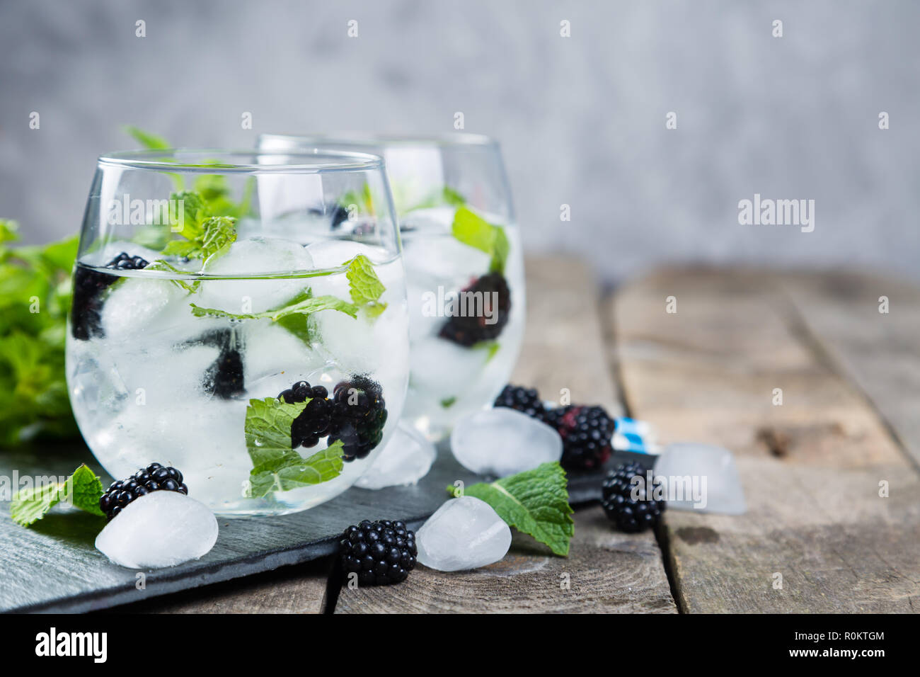 Blackberry mojito and ingredients on rustic background Stock Photo