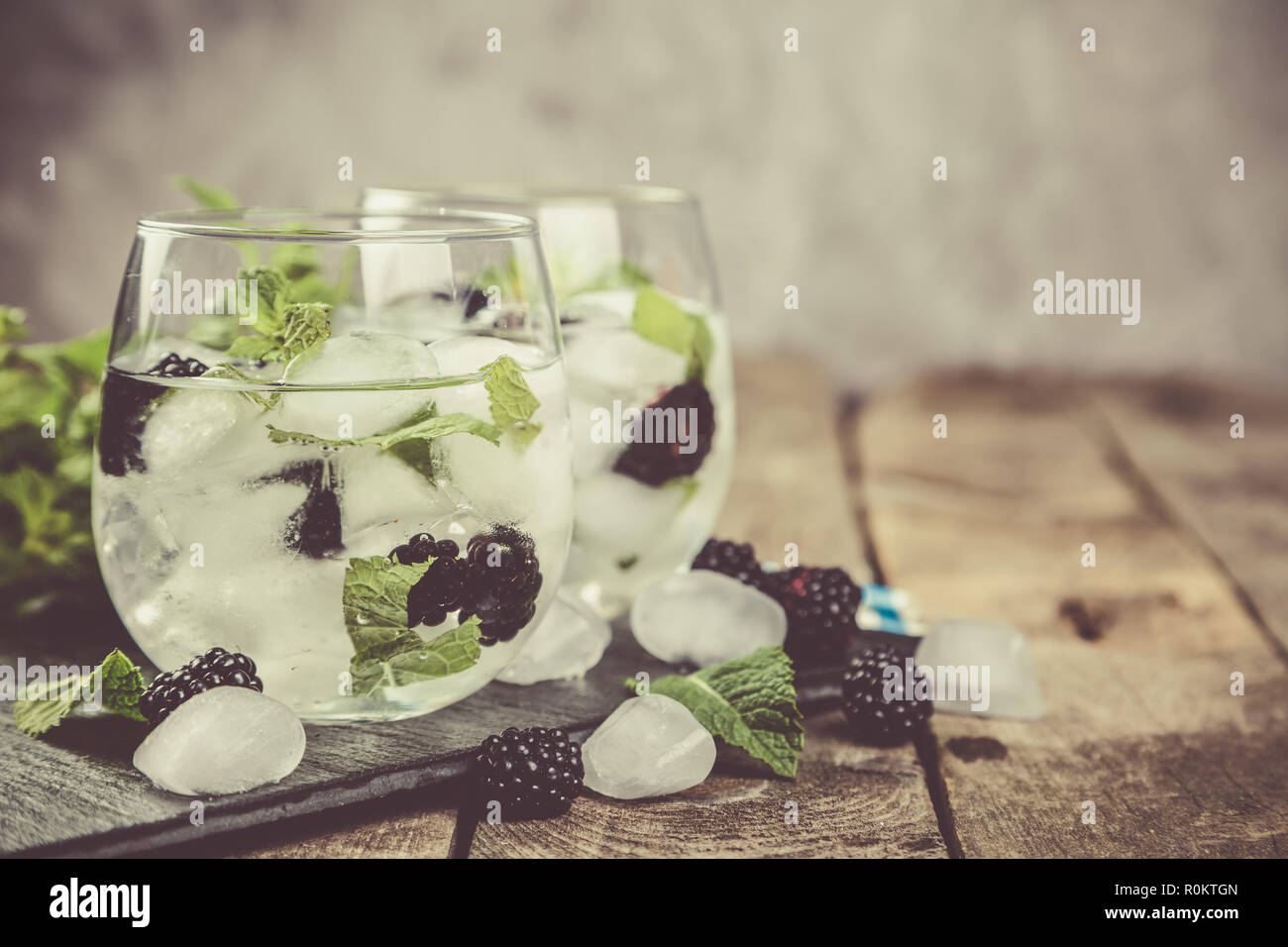 Blackberry mojito and ingredients on rustic background Stock Photo