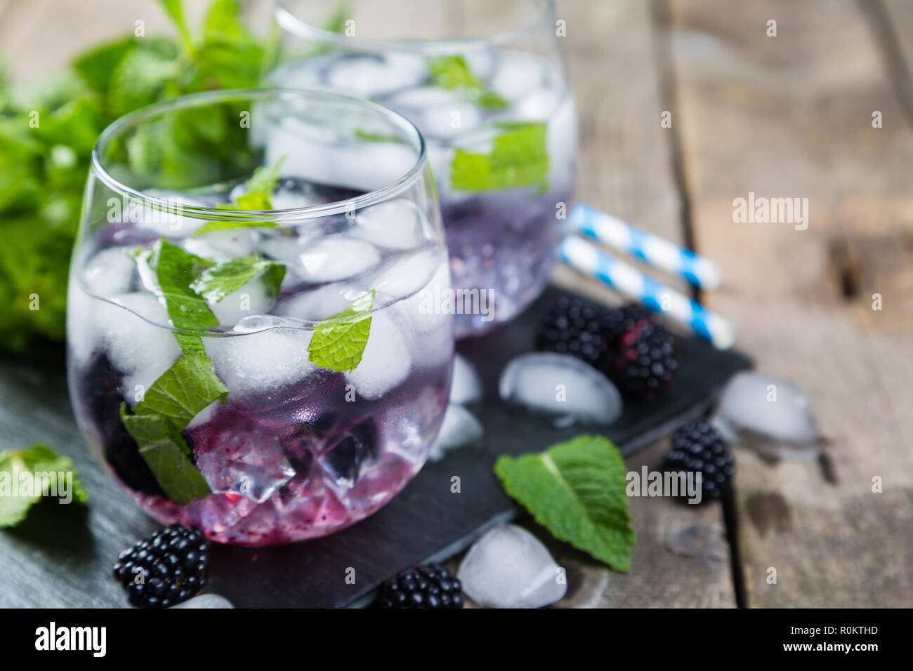 Blackberry mojito and ingredients on rustic background Stock Photo