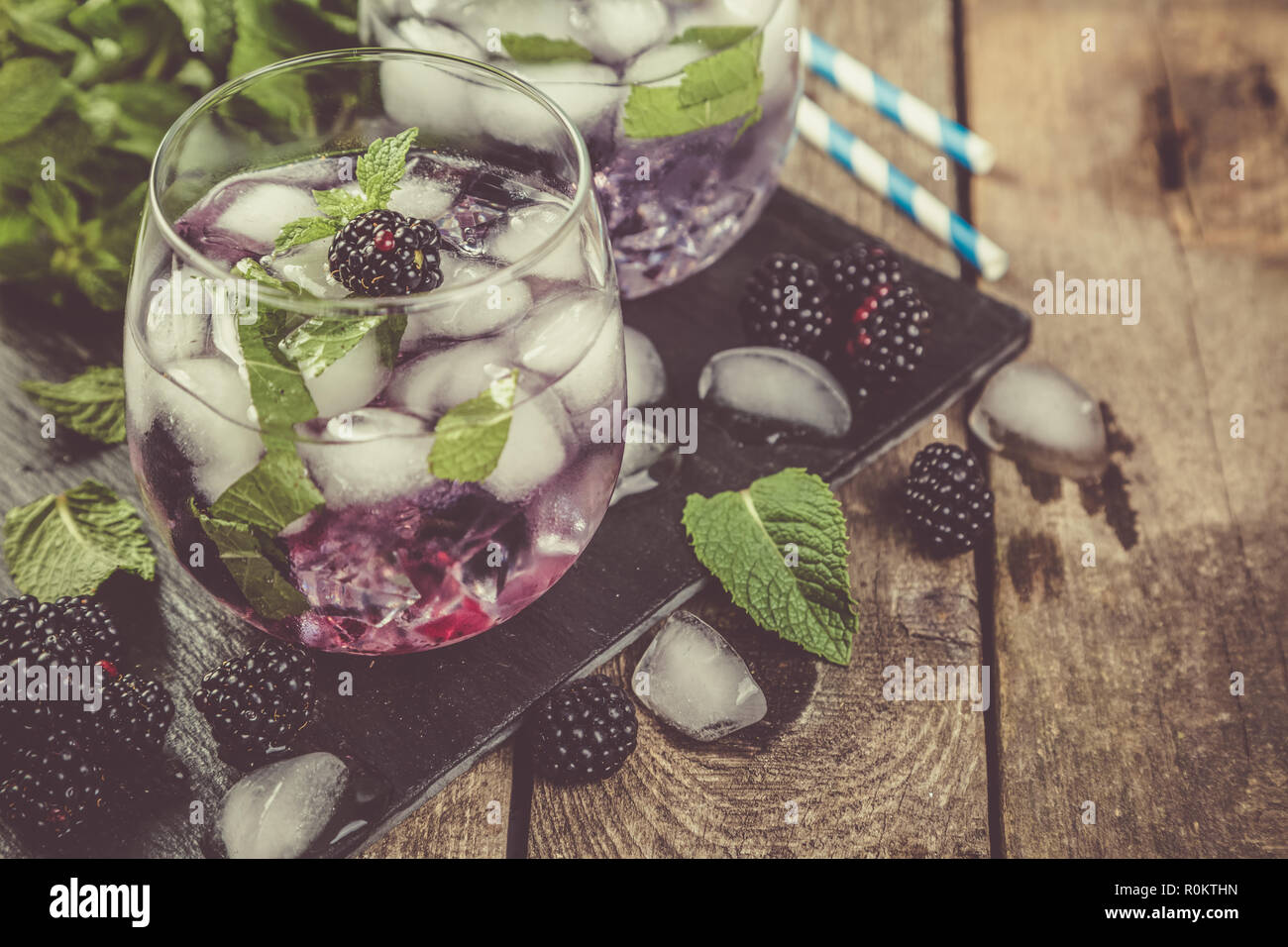 Blackberry mojito and ingredients on rustic background Stock Photo